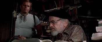 Movie still from “Soylent Green” (1973), directed by Richard Fleischer – An older man sitting in front of a book shelf; Medium shot, Over the shoulder angle