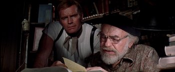 Movie still from “Soylent Green” (1973), directed by Richard Fleischer – A man and a woman looking at a book in a library; Close Up shot, Over the shoulder angle