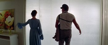 Movie still from “Soylent Green” (1973), directed by Richard Fleischer – A man and a woman standing in front of a white wall; Medium shot, Over the shoulder angle
