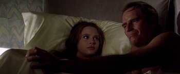 Movie still from “Soylent Green” (1973), directed by Richard Fleischer – A woman laying in a bed next to a man; Close Up shot, Low angle