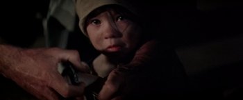 Movie still from “Soylent Green” (1973), directed by Richard Fleischer – A young child holding a cell phone in a dark room; Close Up shot, Over the shoulder angle