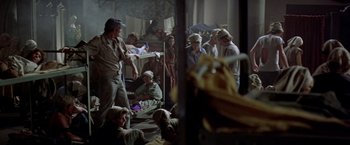 Movie still from “Soylent Green” (1973), directed by Richard Fleischer – A group of people gathered in a room; Wide shot, High angle