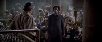 Movie still from “Soylent Green” (1973), directed by Richard Fleischer – A group of people standing in a room; Medium shot, High angle