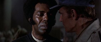 Movie still from “Soylent Green” (1973), directed by Richard Fleischer – Two men are looking at each other in the dark; Close Up shot, Low angle