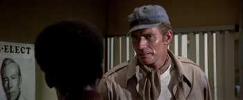 Movie still from “Soylent Green” (1973), directed by Richard Fleischer – A person wearing a hat; Close Up shot, Over the shoulder angle