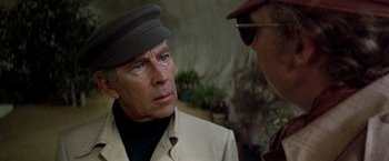 Movie still from “Soylent Green” (1973), directed by Richard Fleischer – An older man wearing a hat and a jacket talking to a younger man; Close Up shot, Over the shoulder angle