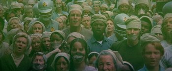 Movie still from “Soylent Green” (1973), directed by Richard Fleischer – A large group of people wearing headbands and masks; Medium shot, High angle