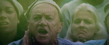 Movie still from “Soylent Green” (1973), directed by Richard Fleischer – An old man with a white hat is yelling at the camera; Close Up shot, Low angle