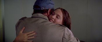 Movie still from “Soylent Green” (1973), directed by Richard Fleischer – A man and a woman hugging each other in a room; Close Up shot, Over the shoulder angle