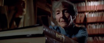 Movie still from “Soylent Green” (1973), directed by Richard Fleischer – An older woman holding a book in her hands; Close Up shot, Low angle