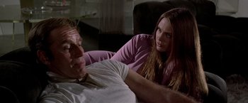 Movie still from “Soylent Green” (1973), directed by Richard Fleischer – A man and a woman sitting on a couch in a living room; Medium shot, Over the shoulder angle