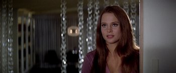 Movie still from “Soylent Green” (1973), directed by Richard Fleischer – A woman with long brown hair standing in a room; Close Up shot, Low angle