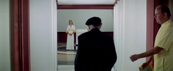 Movie still from “Soylent Green” (1973), directed by Richard Fleischer – An old man and a woman in a room; Wide shot, Over the shoulder angle