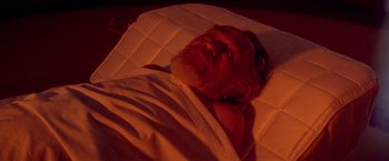 Movie still from “Soylent Green” (1973), directed by Richard Fleischer – An older man laying in bed with a blanket on top of him; Close Up shot, High angle