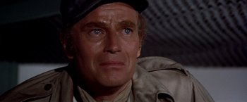 Movie still from “Soylent Green” (1973), directed by Richard Fleischer – A person wearing a hat; Close Up shot, Over the shoulder angle