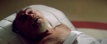 Movie still from “Soylent Green” (1973), directed by Richard Fleischer – An old man with a beard is laying on a bed; Close Up shot, High angle