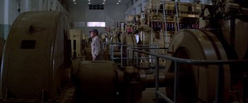Movie still from “Soylent Green” (1973), directed by Richard Fleischer – A man standing next to pipes in a room; Extreme Wide shot, High angle