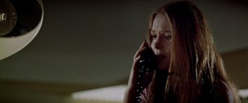 Movie still from “Soylent Green” (1973), directed by Richard Fleischer – A woman on the phone with her eyes wide open; Close Up shot, Low angle