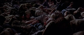 Movie still from “Soylent Green” (1973), directed by Richard Fleischer – A group of people laying on the ground sleeping; Wide shot, High angle