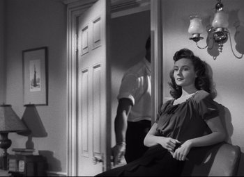 Movie still from “Spellbound” (1945), directed by Alfred Hitchcock – A woman sitting in a chair in front of a mirror; Medium shot, Over the shoulder angle
