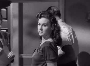 Movie still from “Spellbound” (1945), directed by Alfred Hitchcock – A black and white photo of a woman getting her hair done; Close Up shot, Over the shoulder angle