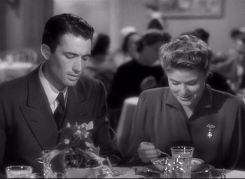 Movie still from “Spellbound” (1945), directed by Alfred Hitchcock – A man and a woman sitting at a dinner table; Medium shot, Over the shoulder angle
