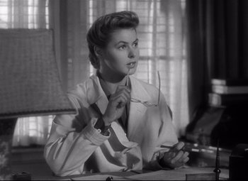 Movie still from “Spellbound” (1945), directed by Alfred Hitchcock – An old photo of a woman tying a neck tie; Close Up shot, Low angle