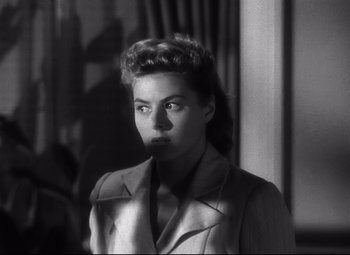 Movie still from “Spellbound” (1945), directed by Alfred Hitchcock – A black - and - white photo of a woman in a suit; Close Up shot, High angle