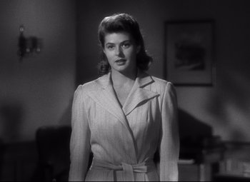 Movie still from “Spellbound” (1945), directed by Alfred Hitchcock – A black and white photo of a woman in a suit; Close Up shot, Over the shoulder angle