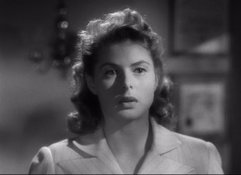 Movie still from “Spellbound” (1945), directed by Alfred Hitchcock – A black - and - white photo of a woman in a white shirt; Close Up shot, Over the shoulder angle