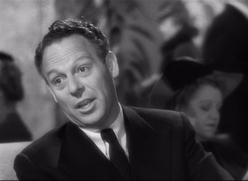 Movie still from “Spellbound” (1945), directed by Alfred Hitchcock – An old photo of a man in a suit and tie; Close Up shot, Over the shoulder angle