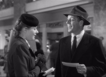 Movie still from “Spellbound” (1945), directed by Alfred Hitchcock – A man and a woman talking to each other in front of a building; Medium shot, Over the shoulder angle