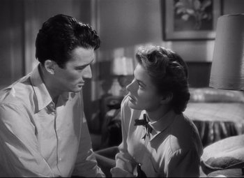 Movie still from “Spellbound” (1945), directed by Alfred Hitchcock – A man and a woman sitting in a living room talking; Medium shot, Over the shoulder angle