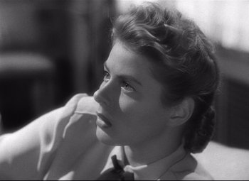 Movie still from “Spellbound” (1945), directed by Alfred Hitchcock – A black - and - white photo of a young woman looking to her left; Close Up shot, Low angle