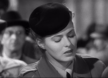 Movie still from “Spellbound” (1945), directed by Alfred Hitchcock – A woman wearing a black hat and a uniform; Close Up shot, Over the shoulder angle