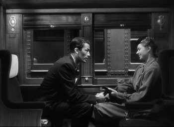 Movie still from “Spellbound” (1945), directed by Alfred Hitchcock – A man and a woman sitting on a bench; Medium shot, High angle