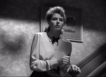 Movie still from “Spellbound” (1945), directed by Alfred Hitchcock – A black and white photo of a woman in a dress shirt and tie; Close Up shot, Low angle
