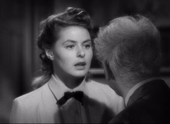 Movie still from “Spellbound” (1945), directed by Alfred Hitchcock – An old photo of a man and a woman talking; Close Up shot, Over the shoulder angle