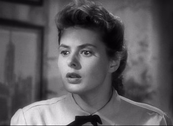 Movie still from “Spellbound” (1945), directed by Alfred Hitchcock – A black and white photo of a woman with a black tie; Close Up shot, Low angle
