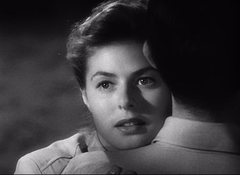 Movie still from “Spellbound” (1945), directed by Alfred Hitchcock – A black - and - white photo of a woman looking at the camera; Close Up shot, Over the shoulder angle