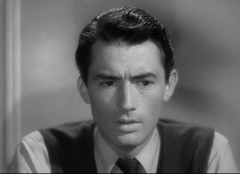 Movie still from “Spellbound” (1945), directed by Alfred Hitchcock – A black and white photo of a man in a suit and tie; Close Up shot, High angle