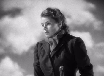 Movie still from “Spellbound” (1945), directed by Alfred Hitchcock – A black and white photo of a woman in a coat; Close Up shot, Low angle