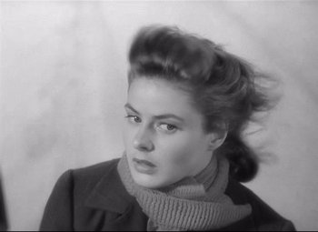 Movie still from “Spellbound” (1945), directed by Alfred Hitchcock – A black and white photo of a woman in a coat and a scarf; Close Up shot, Over the shoulder angle