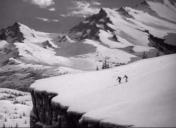Movie still from “Spellbound” (1945), directed by Alfred Hitchcock – Two skiers are skiing down a mountain side; Extreme Wide shot, High angle
