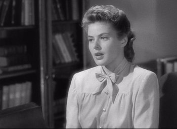 Movie still from “Spellbound” (1945), directed by Alfred Hitchcock – A black and white photo of a woman with a bow tie; Close Up shot, Low angle