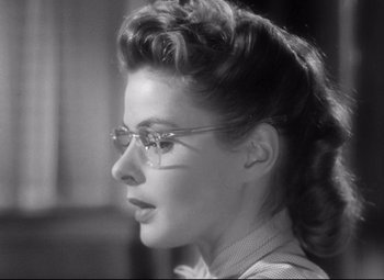 Movie still from “Spellbound” (1945), directed by Alfred Hitchcock – A woman wearing glasses looking to the side; Close Up shot, Low angle