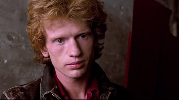 Movie still from “Spetters” (1980), directed by Paul Verhoeven – A person wearing a leather jacket; Close Up shot, Low angle
