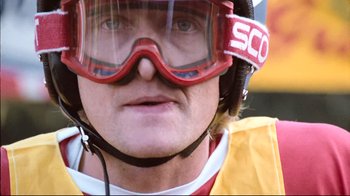 Movie still from “Spetters” (1980), directed by Paul Verhoeven – A person wearing a helmet and goggles; Close Up shot, Low angle