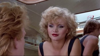 Movie still from “Spetters” (1980), directed by Paul Verhoeven – A person wearing a dress; Close Up shot, Low angle