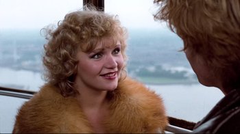 Movie still from “Spetters” (1980), directed by Paul Verhoeven – A person wearing a fur coat; Close Up shot, Over the shoulder angle